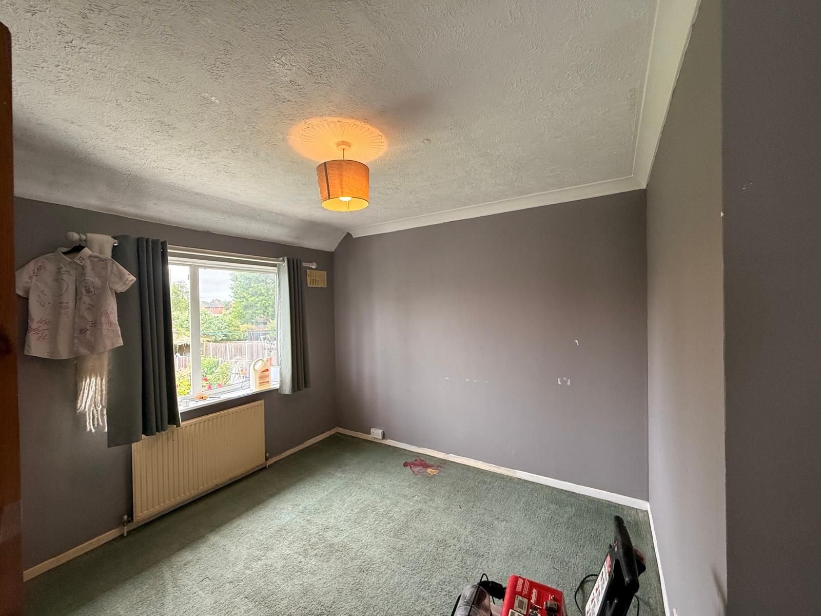 Bedroom before redecoration with marked grey walls