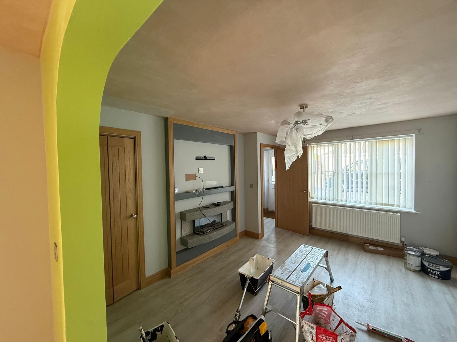 Living room before: lime green walls and bare new plaster