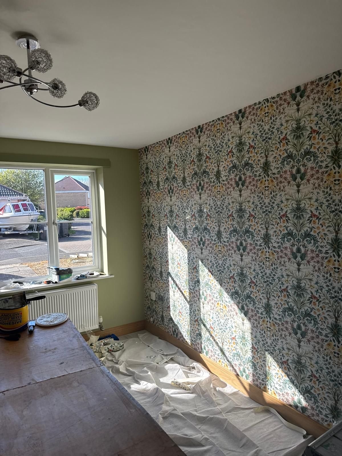 Botanical feature wallpaper with sage green walls